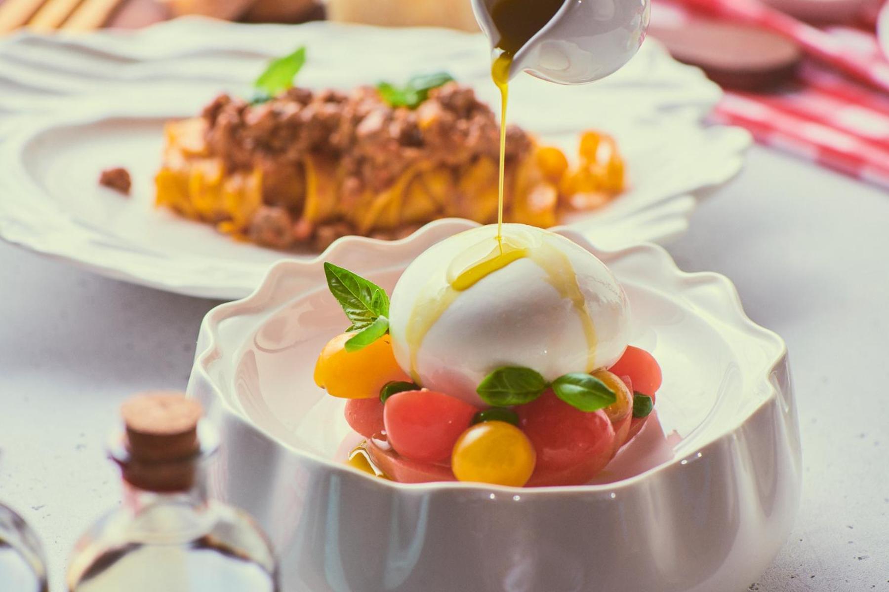 Five Jumeirah Village Dubai Buitenkant foto A salad being drizzled with olive oil